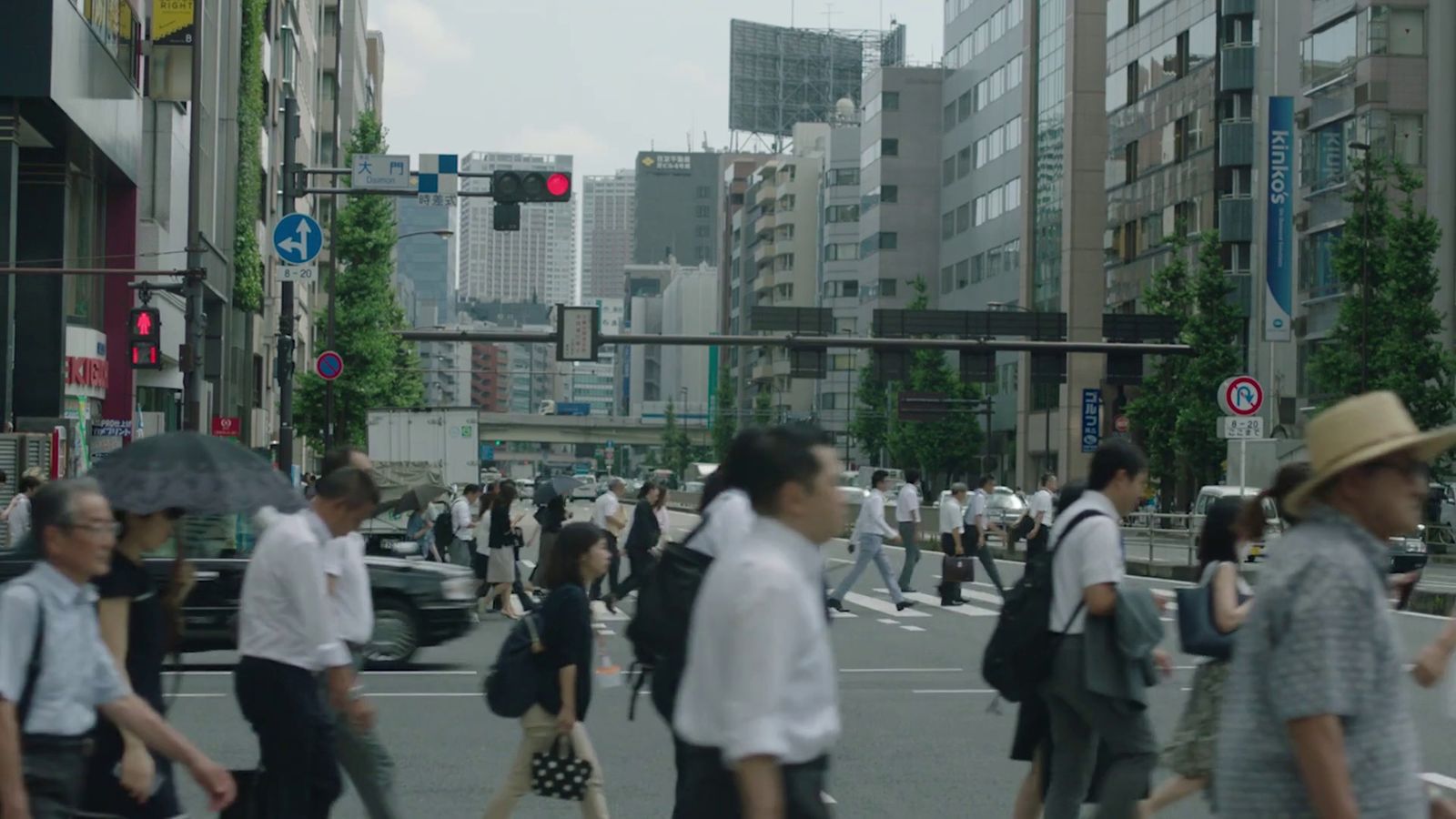 a group of people walking across a street