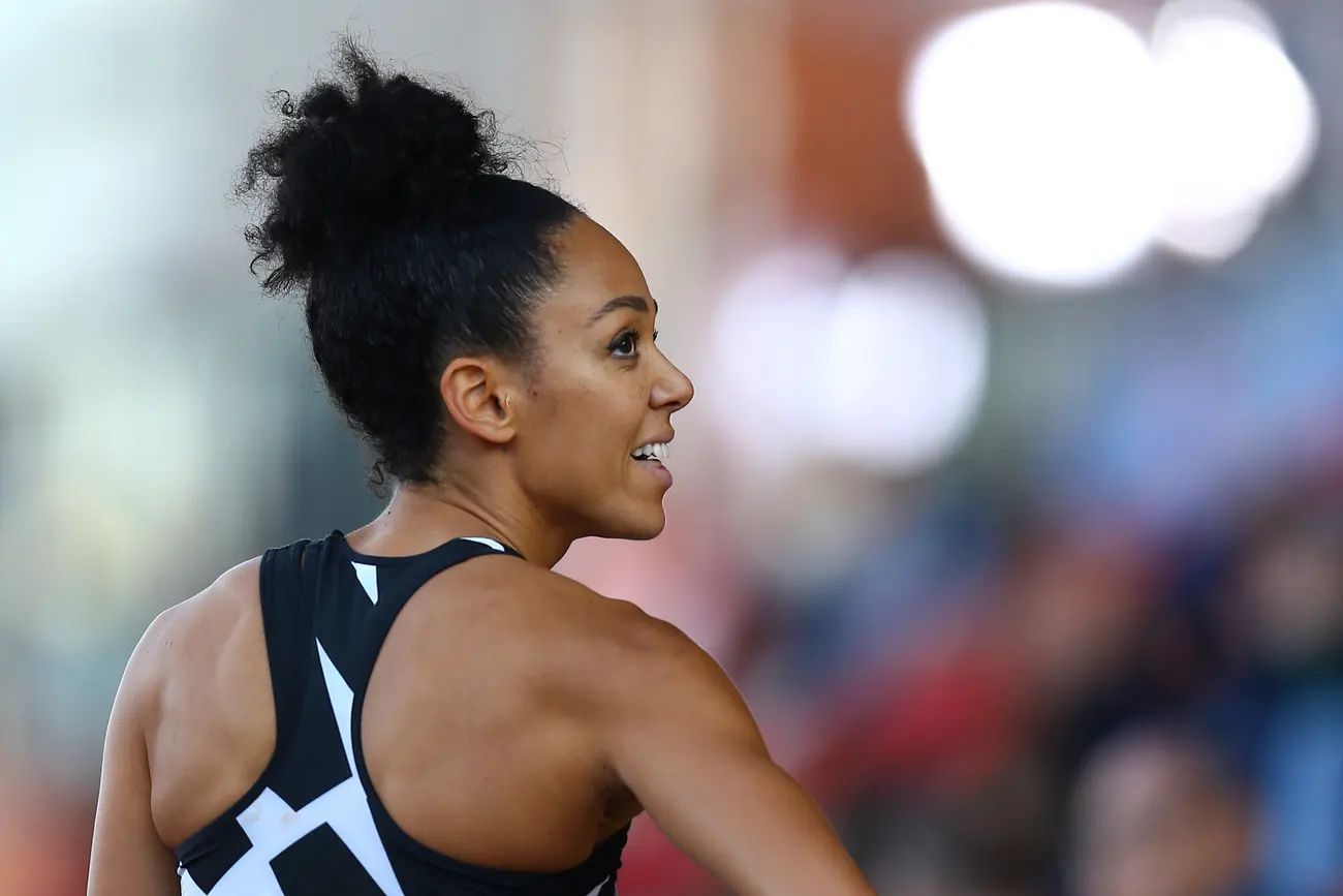 a woman in a black and white top is running