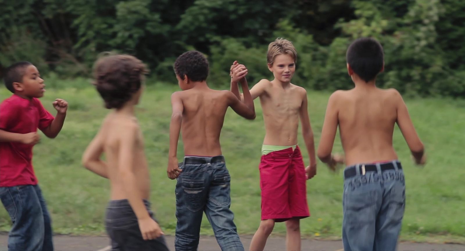 a group of young boys standing next to each other