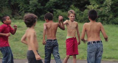 a group of young boys standing next to each other