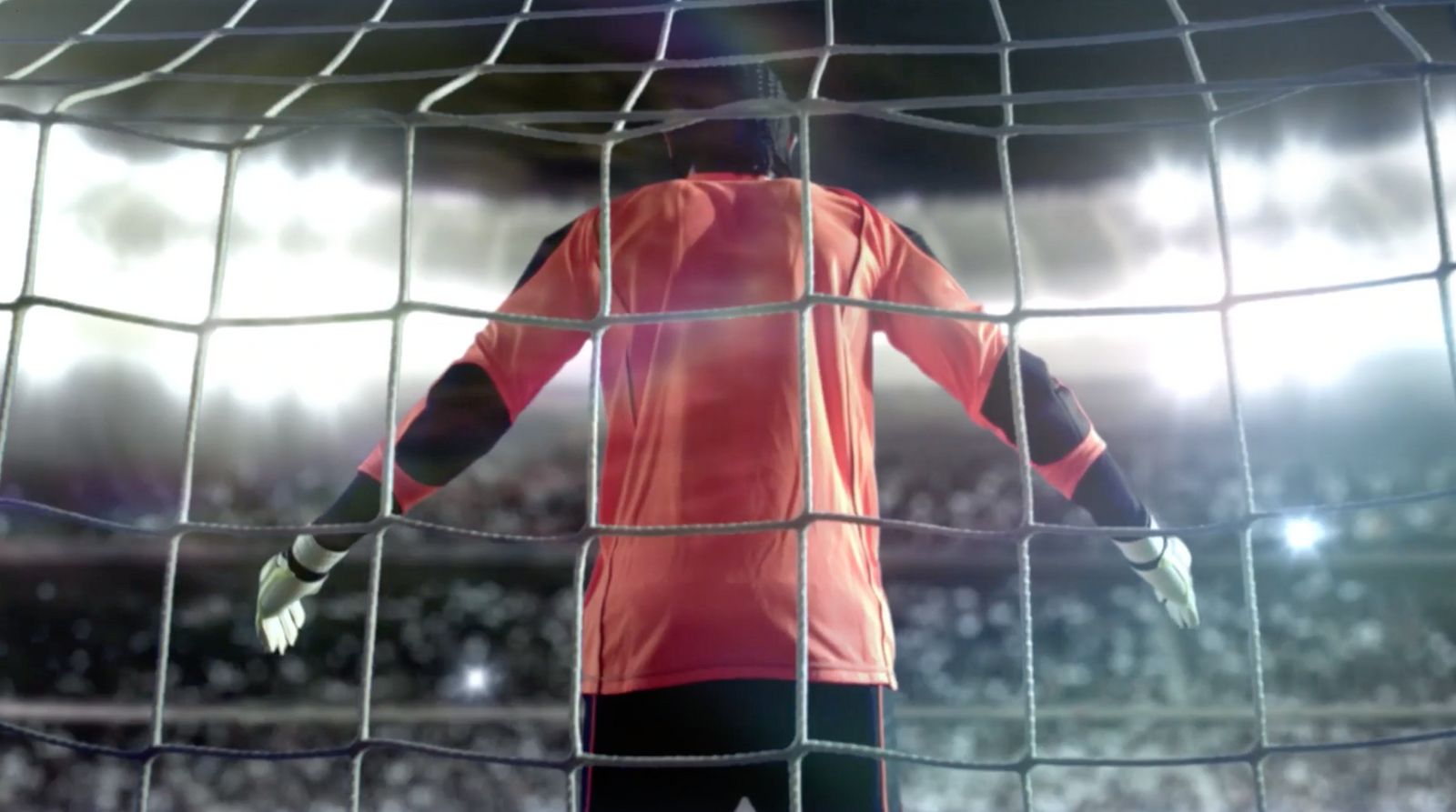 a soccer goalie standing in front of a net