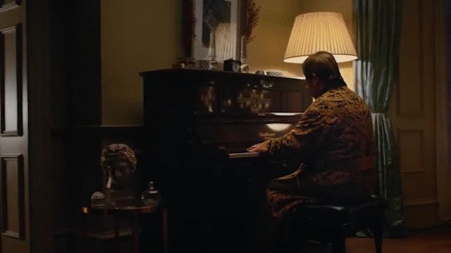 a person sitting at a piano in a room