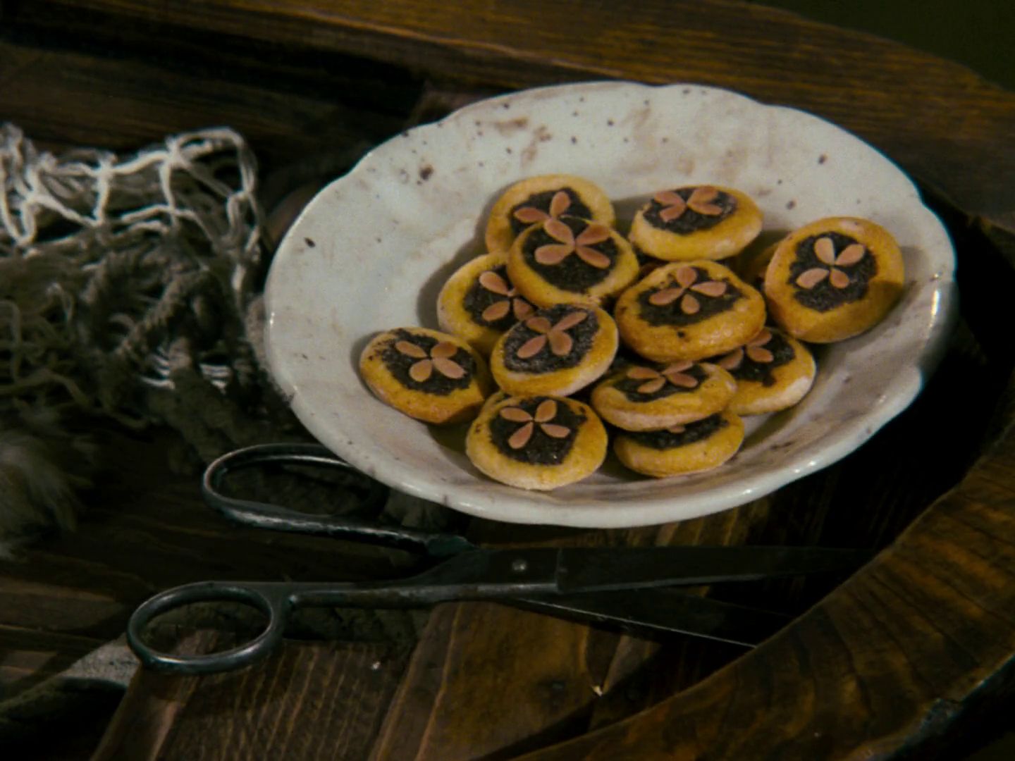 a white bowl filled with cookies on top of a wooden table