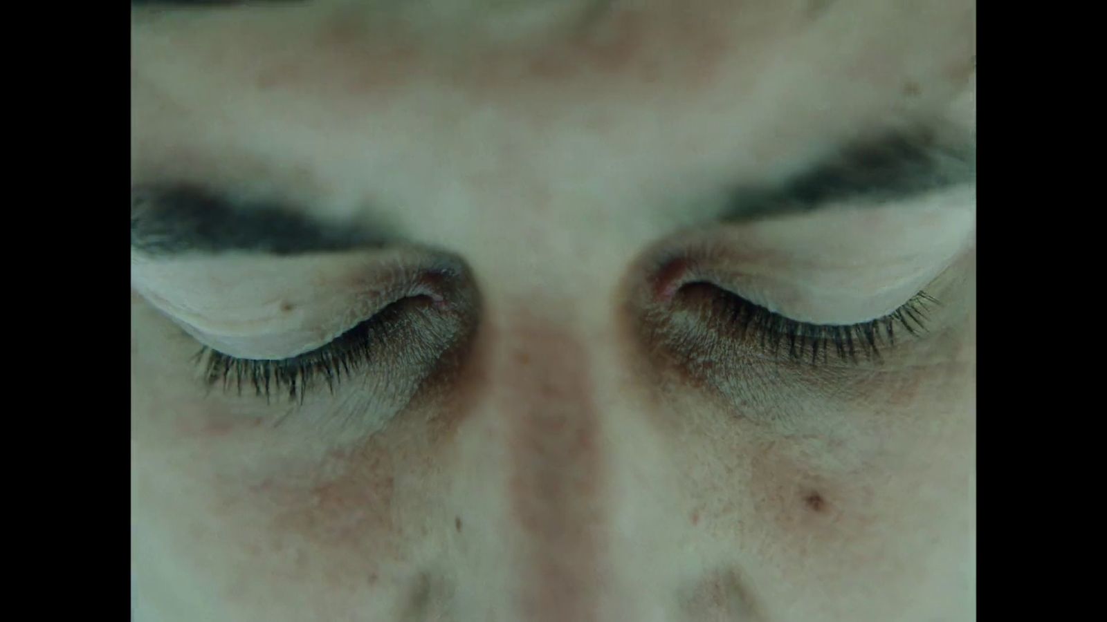 a close up of a woman's eye with long lashes