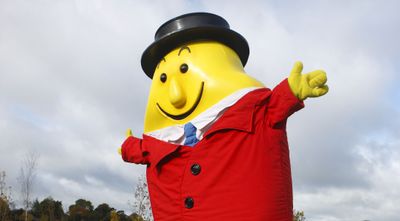 a large inflatable statue of a man in a suit and tie