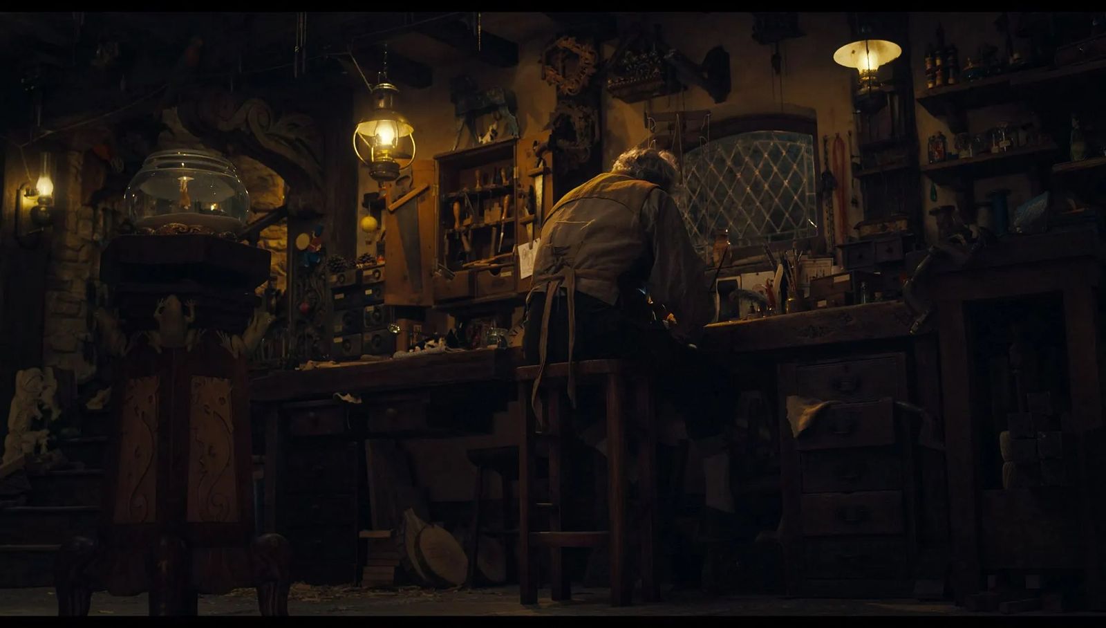 a man sitting at a table in a dark room