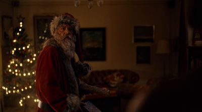 a man dressed as santa claus in a living room