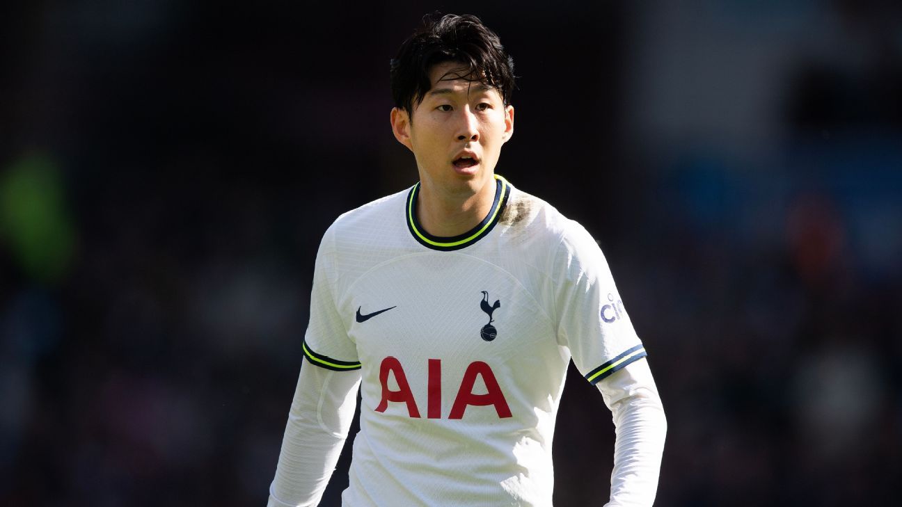 a young man in a white shirt is playing soccer