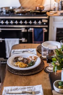 a wooden table topped with a plate of food