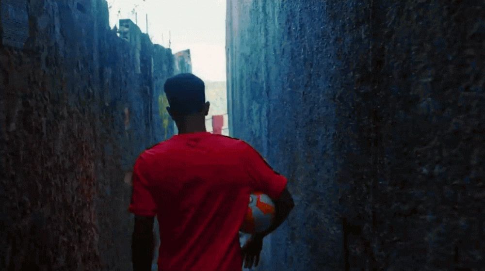 a man walking down a narrow alley way