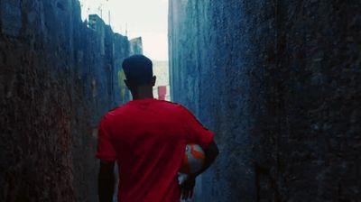 a man walking down a narrow alley way