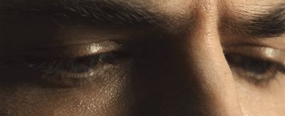 a close up of a man's eye with a mustache