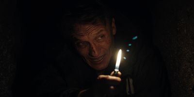 a man holding a lit candle in his hand