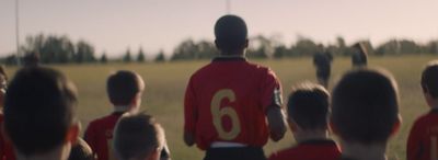 a group of children watching a soccer game