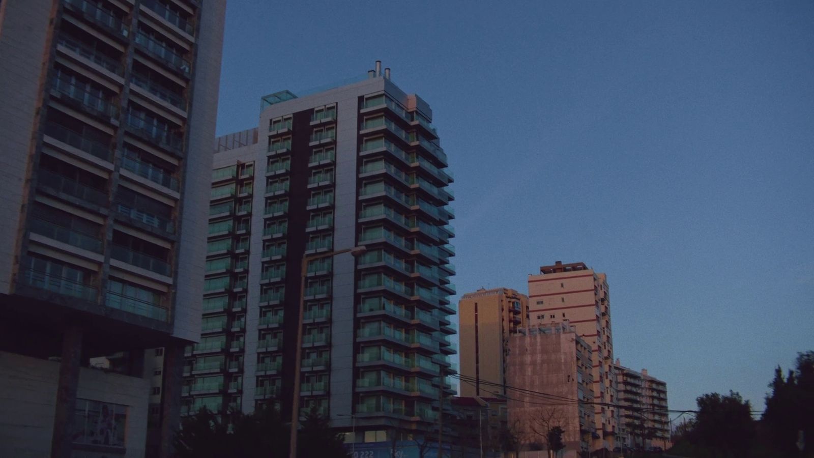 a couple of tall buildings sitting next to each other