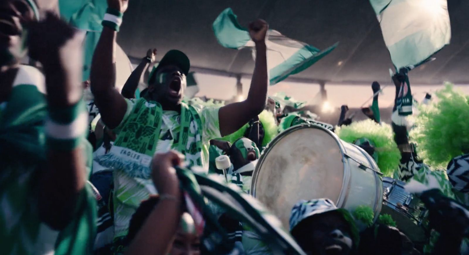 a group of people holding flags and drums