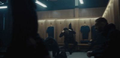 a group of people standing in front of a locker