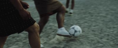 a close up of a person kicking a soccer ball