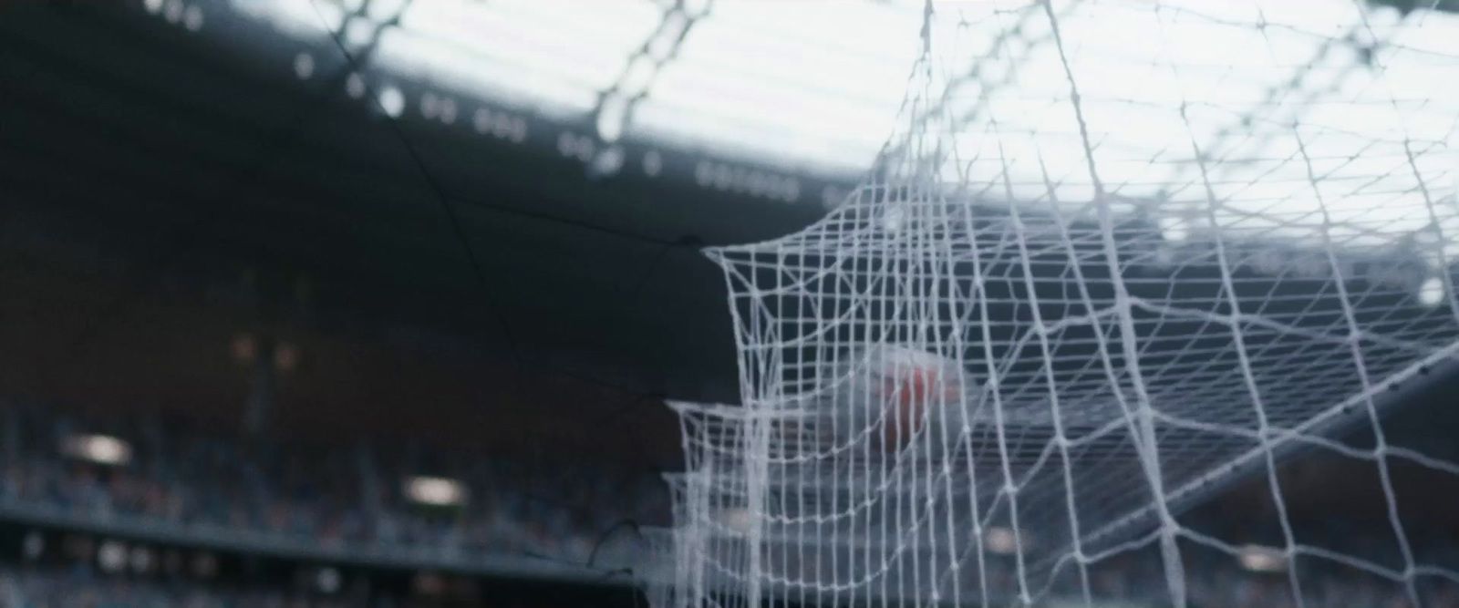 a blurry photo of a soccer goal in a stadium