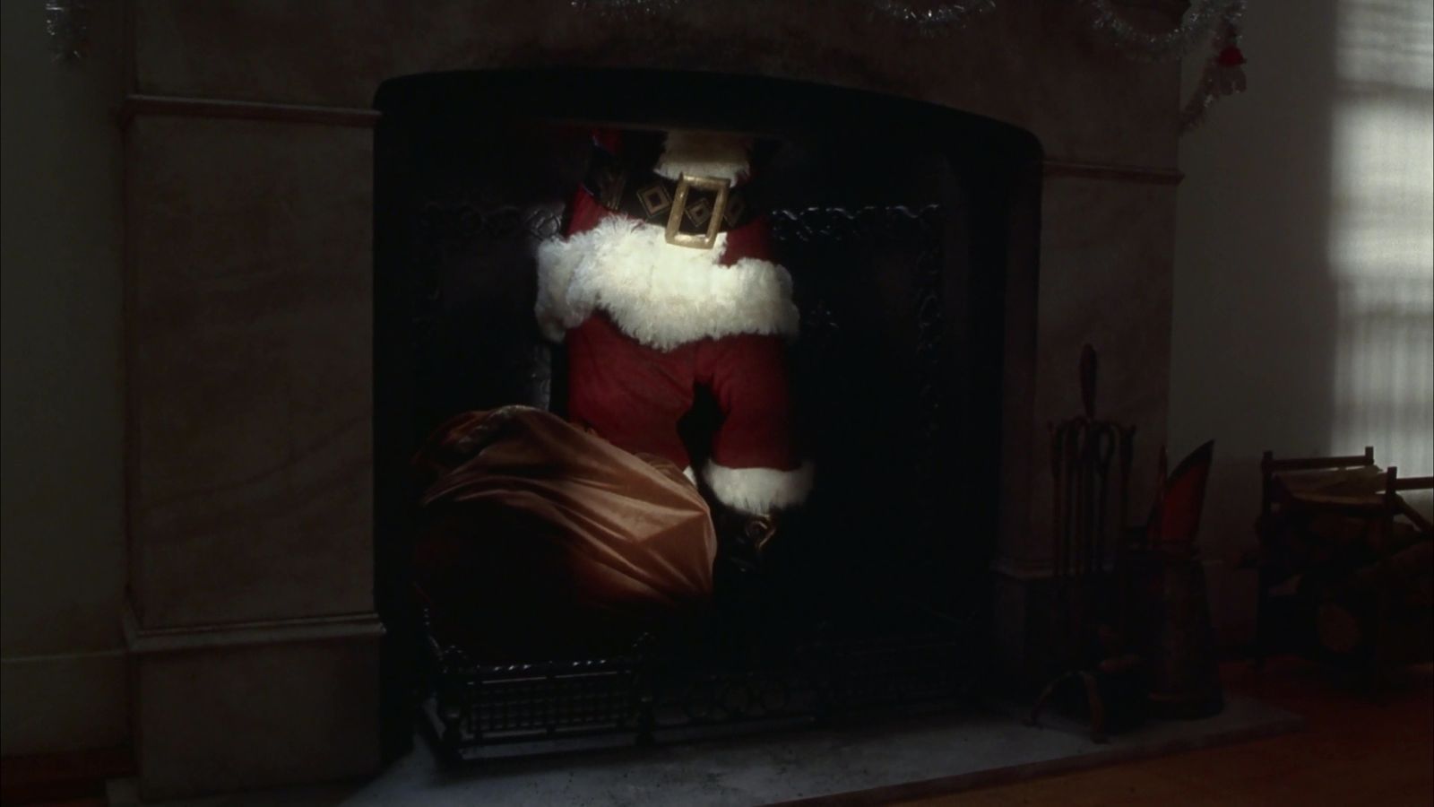 a fireplace with a santa suit on it