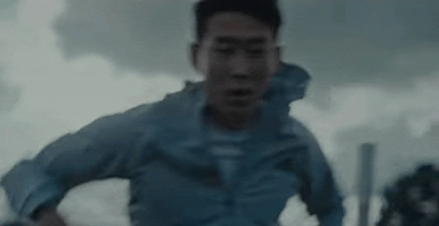 a man running in the rain with his mouth open