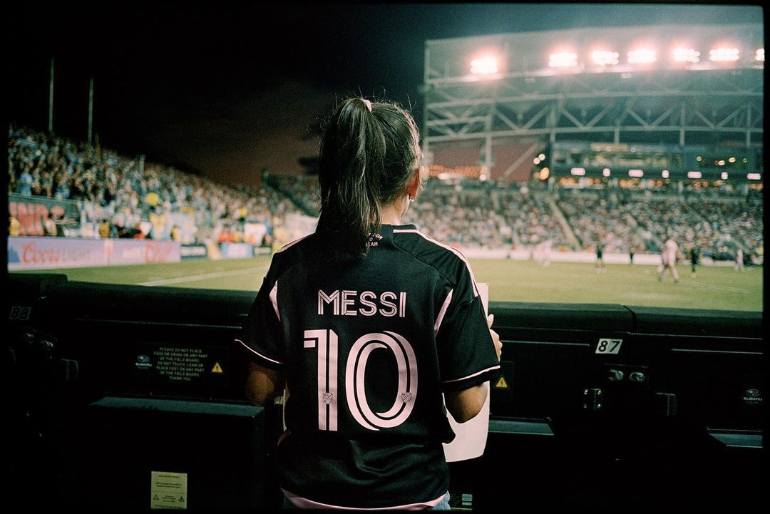 a female soccer player is watching a game