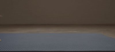 a blue mat sitting on top of a wooden floor