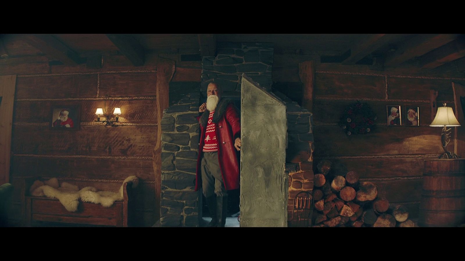 a man standing in a doorway of a log cabin