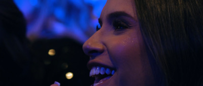 a close up of a woman brushing her teeth