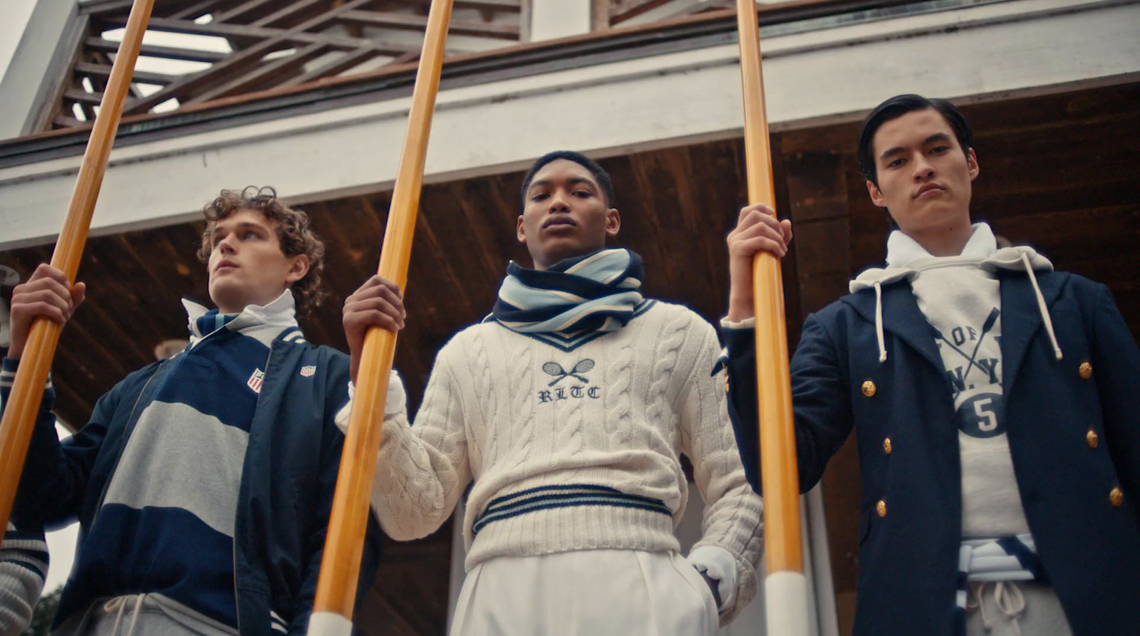 a group of men standing next to each other holding baseball bats