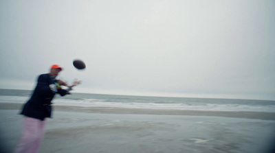 a man on the beach playing with a frisbee