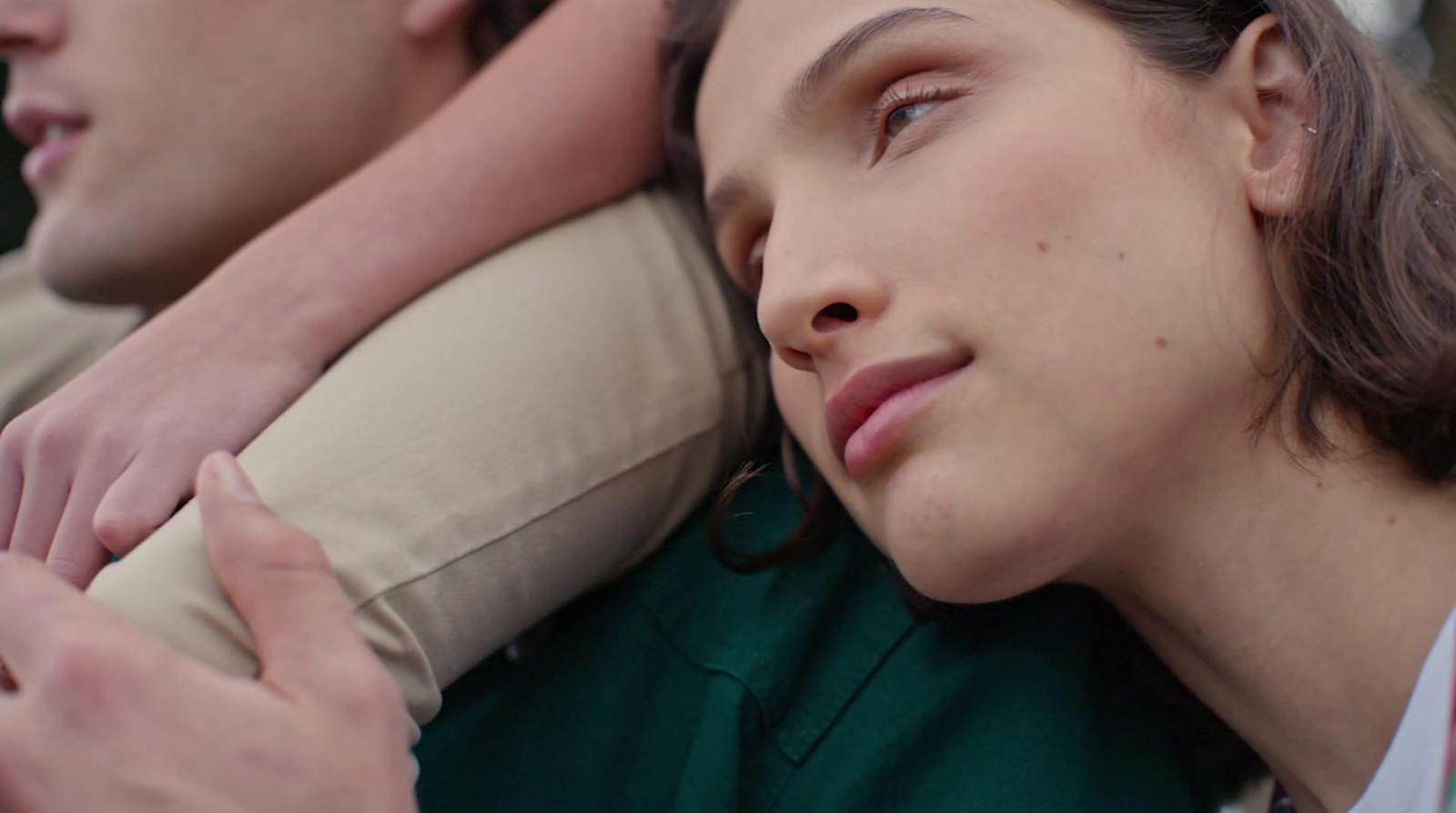 a close up of a person laying on a pillow