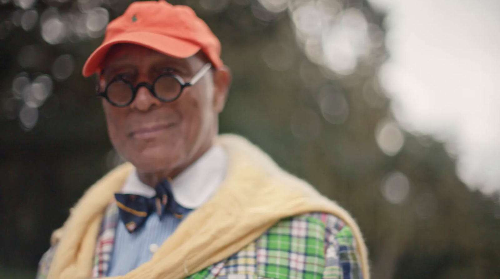 an older man wearing a hat and glasses