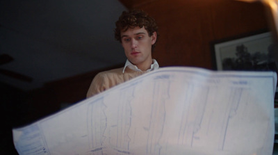 a man holding a bunch of papers in his hands