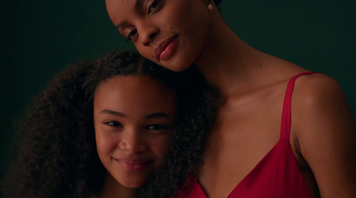 a woman and a young girl posing for a picture