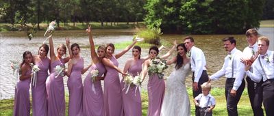 a group of people standing next to each other in front of a lake