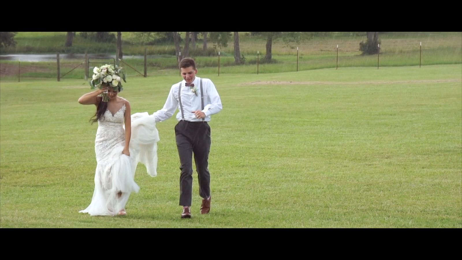 a bride and groom walking through a field