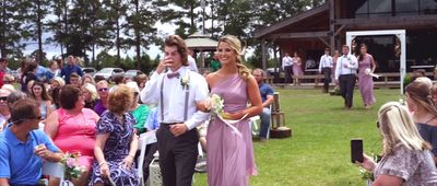 a man and a woman are walking down the aisle