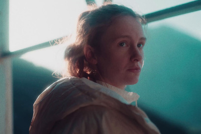 a woman standing in front of a window