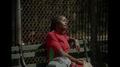 a woman sitting on a bench with her eyes closed