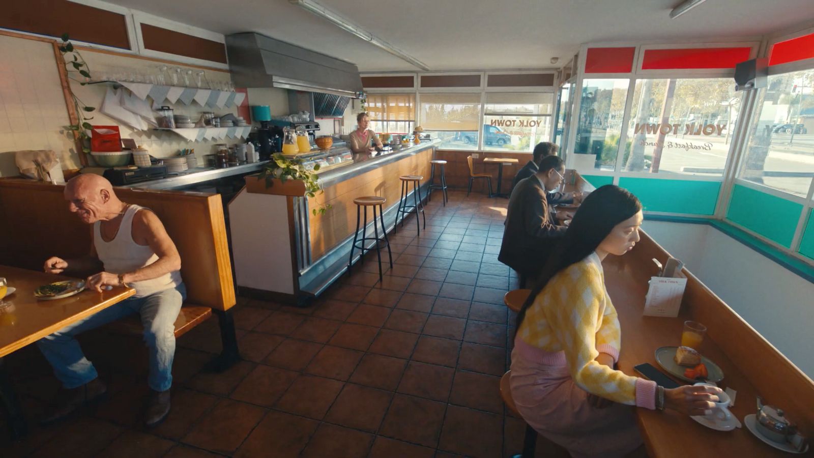 a couple of people sitting at a table in a restaurant