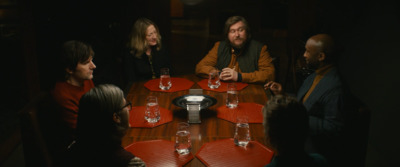 a group of people sitting around a wooden table
