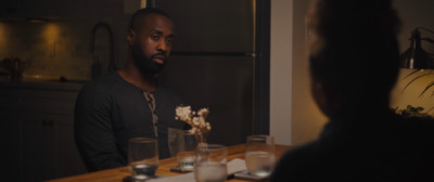 a man sitting at a table in a dark room