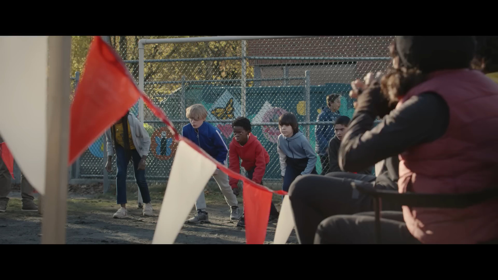 a group of people standing next to each other near a fence