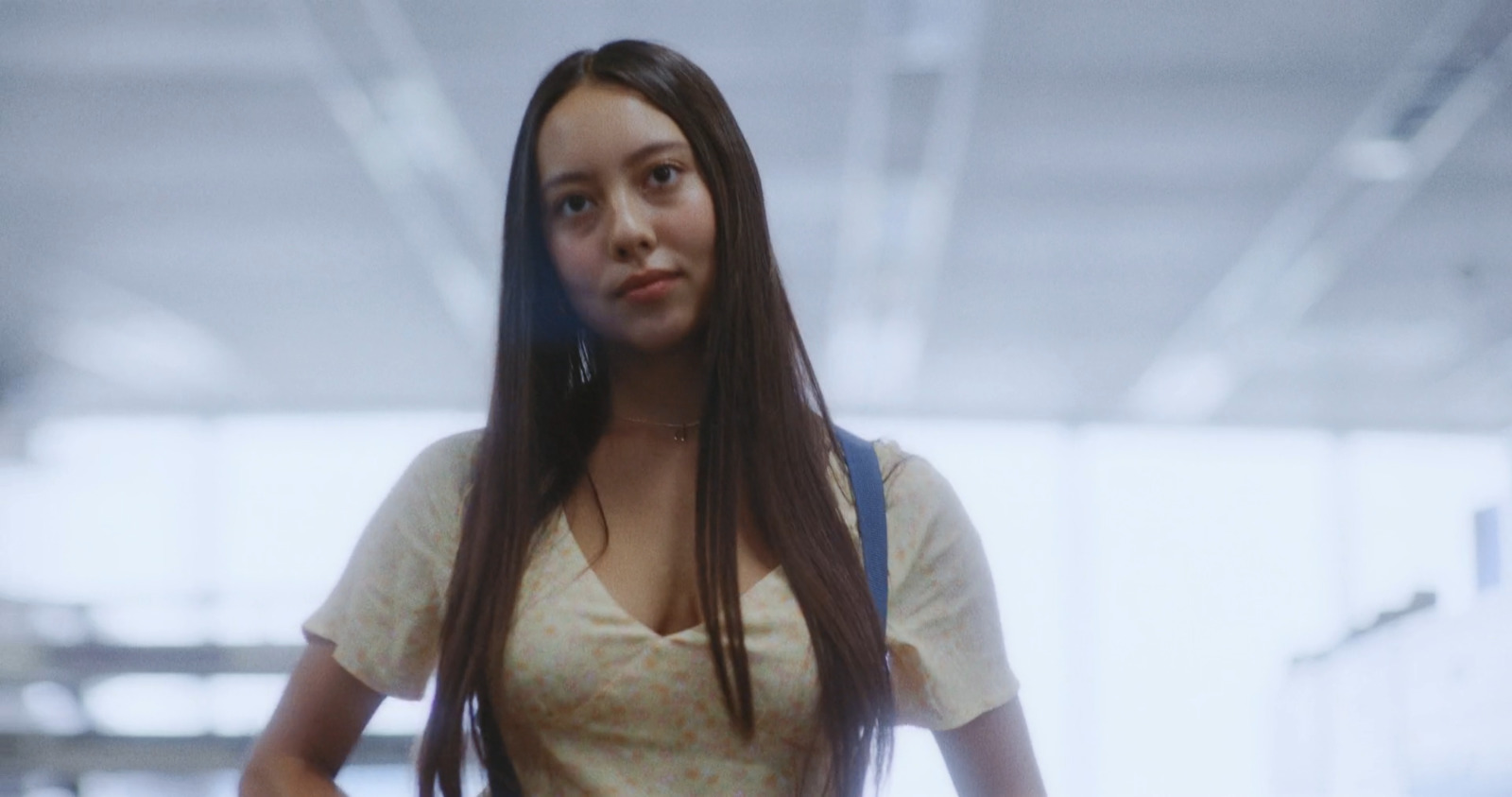 a woman with long hair standing in a building