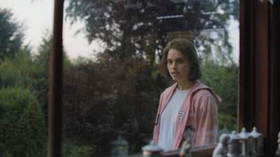 a woman standing in front of a window