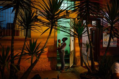 a man and a woman standing in a doorway at night