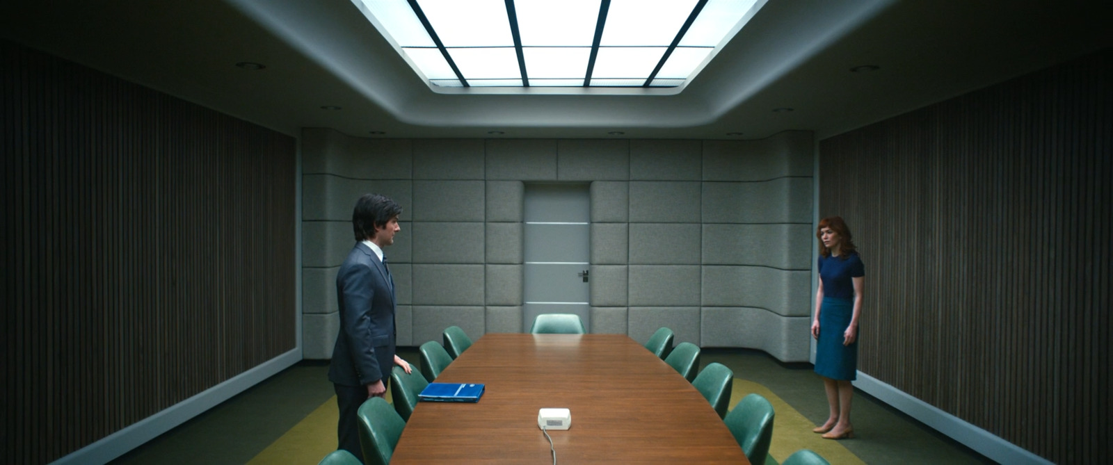 a man and a woman standing in a conference room