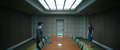 a man and a woman standing in a conference room