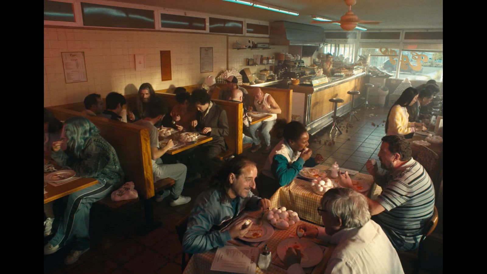 a group of people sitting around a table eating food